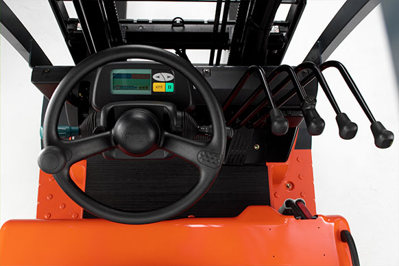 Operator's point of view showing the steering wheel of a Toyota electric forklift, as well as the lifting controls of the lift truck.